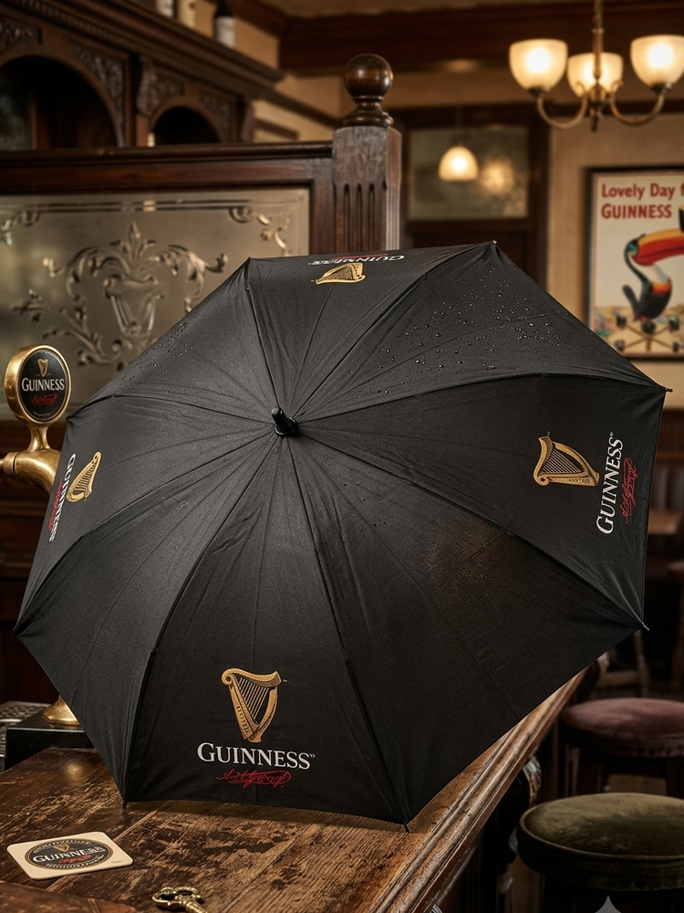 Black umbrella with Guinness logo on a bar counter in a pub setting