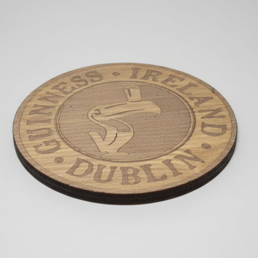 Wooden coaster with Guinness Ireland Dublin branding on a dark background